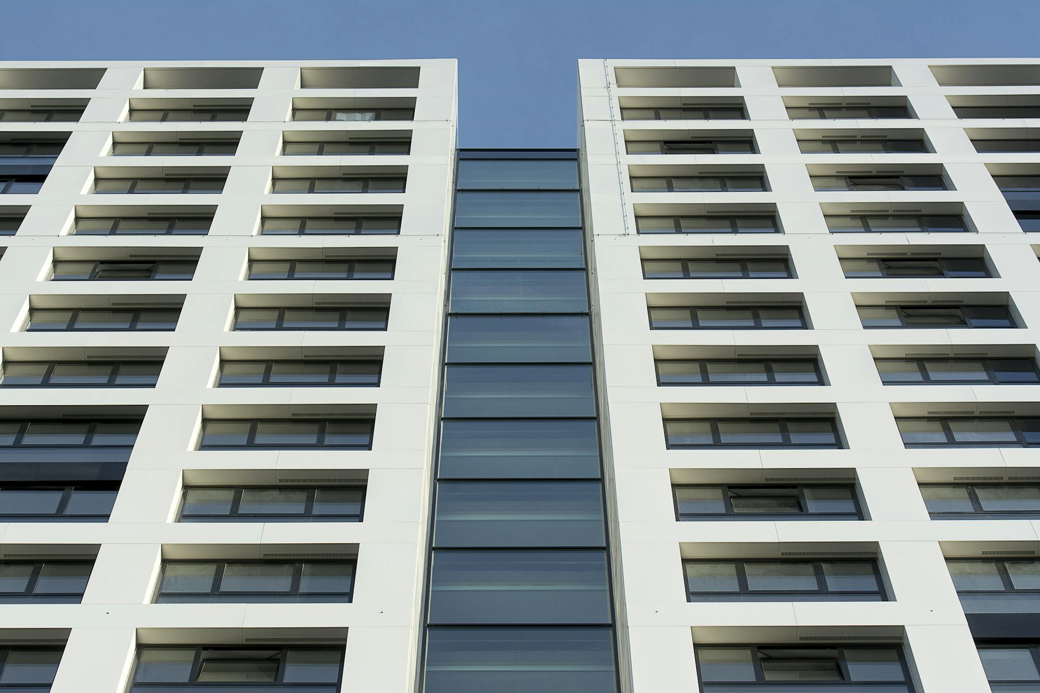 Contemporary skyscraper facade showcasing glass and steel materials in an urban setting.