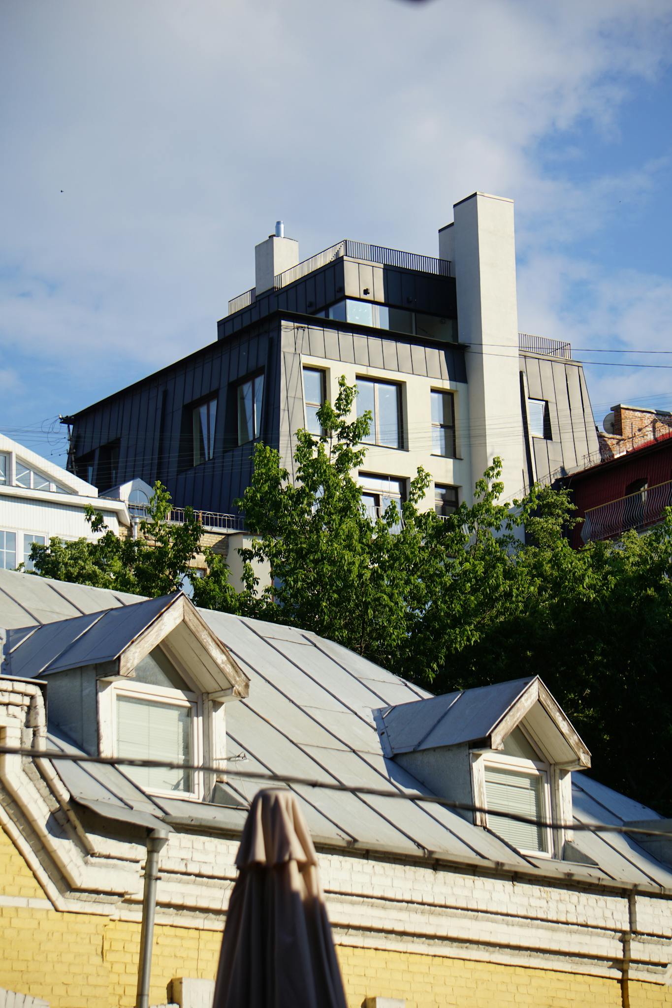 Modern buildings and lush greenery in Kyiv's urban skyline.